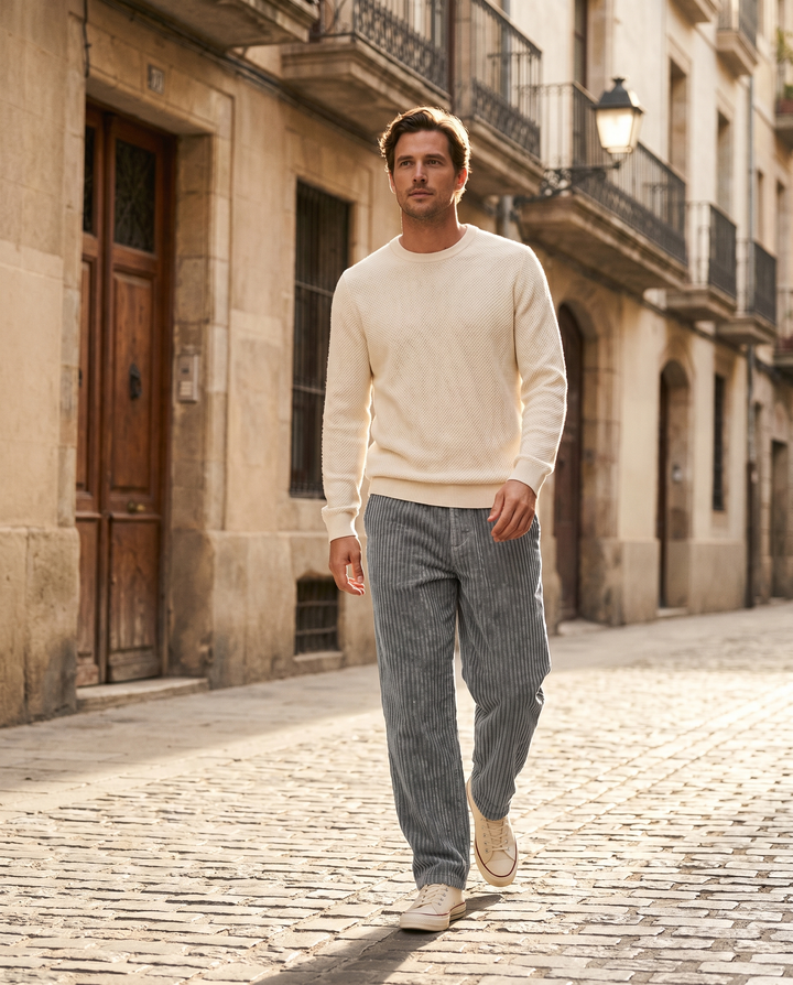 Man wearing Monaco corduroy trousers walking a sunlit street