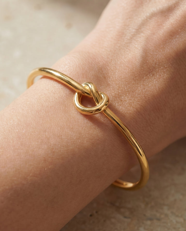 Close-up detail of the gold knot on the cuff bracelet