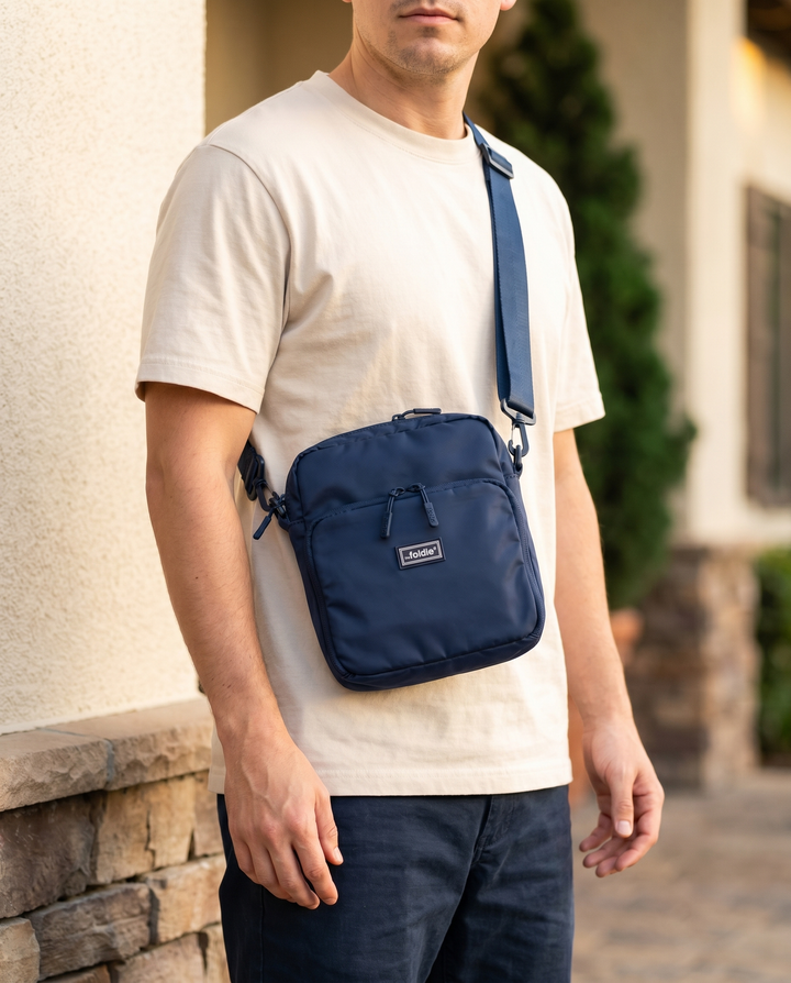 Foldable crossbody sling bag in Navy, worn