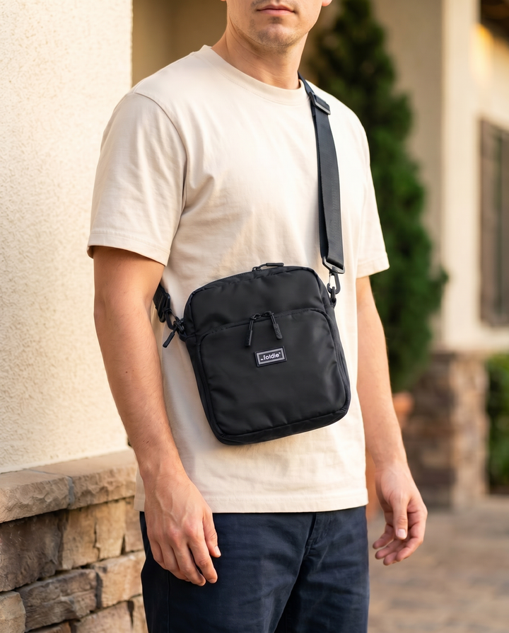 Foldable crossbody sling bag in Black, worn