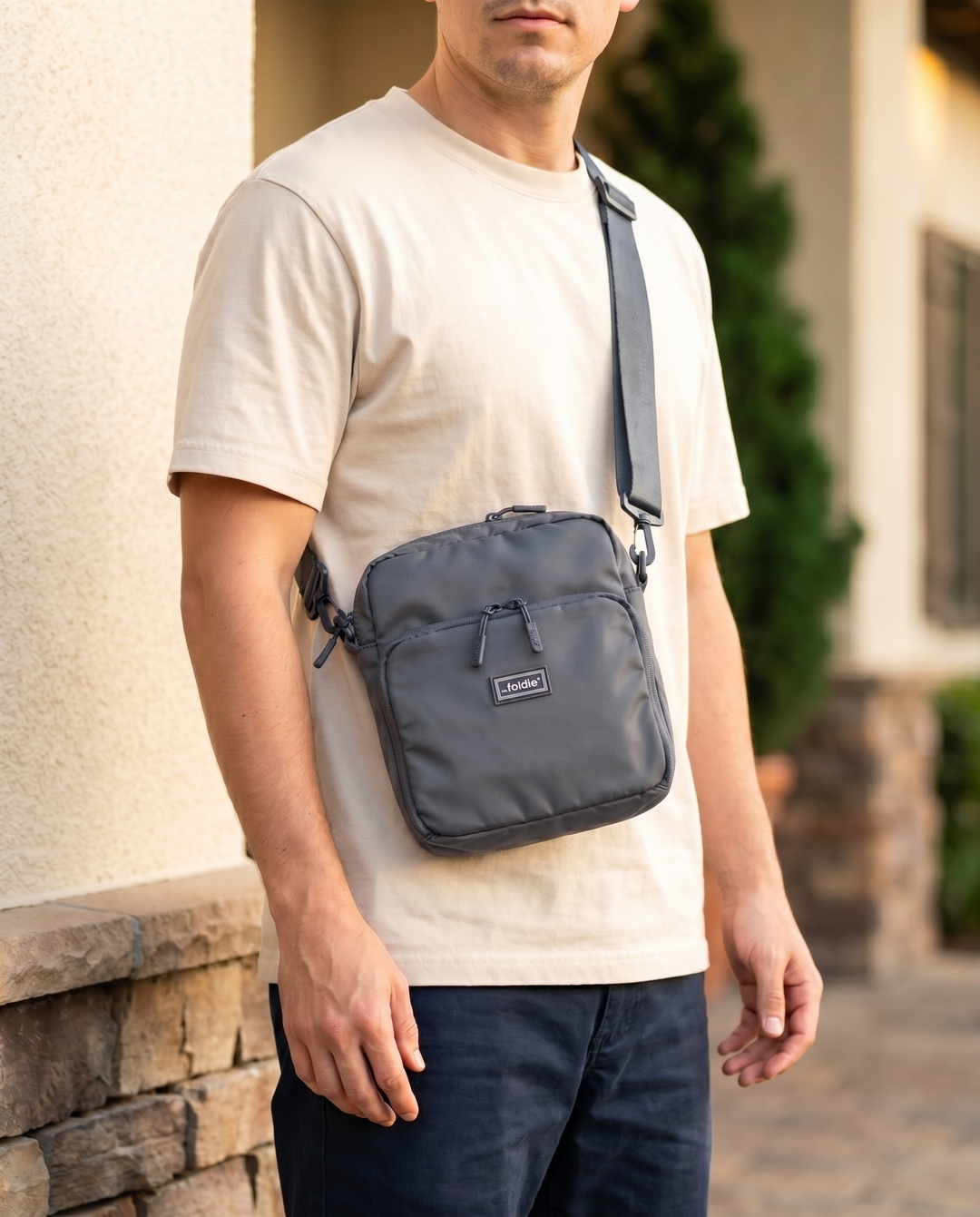 Foldable crossbody sling bag in Grey, worn