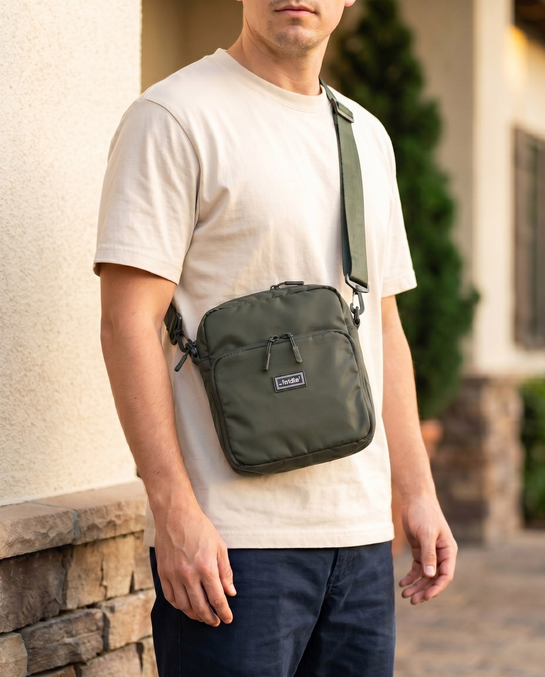 Foldable crossbody sling bag in Army Green, worn