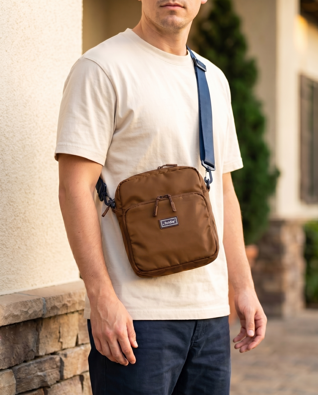 Foldable crossbody sling bag in Brown, worn