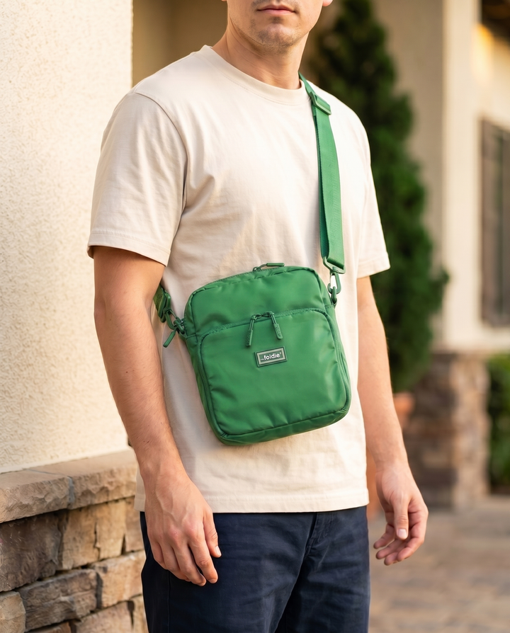 Foldable crossbody sling bag in Grass Green, worn