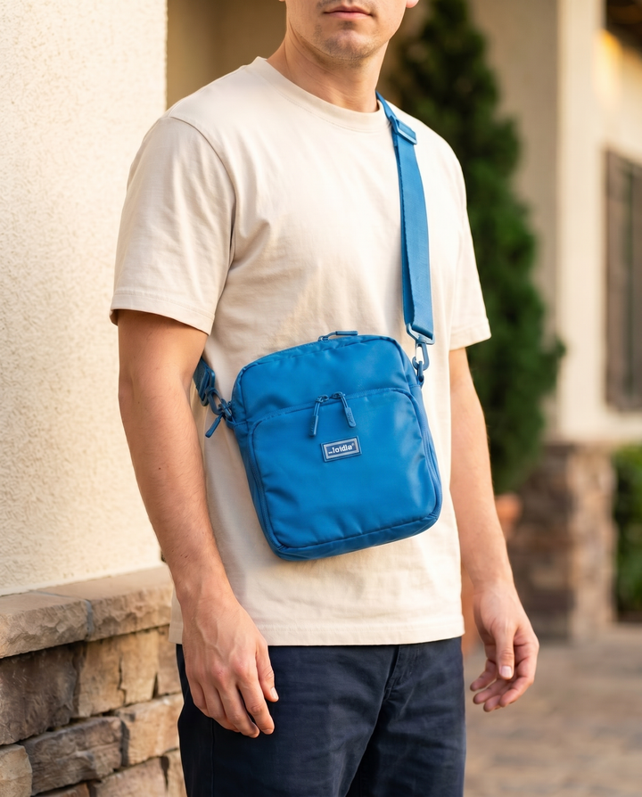 Foldable crossbody sling bag in Azure, worn