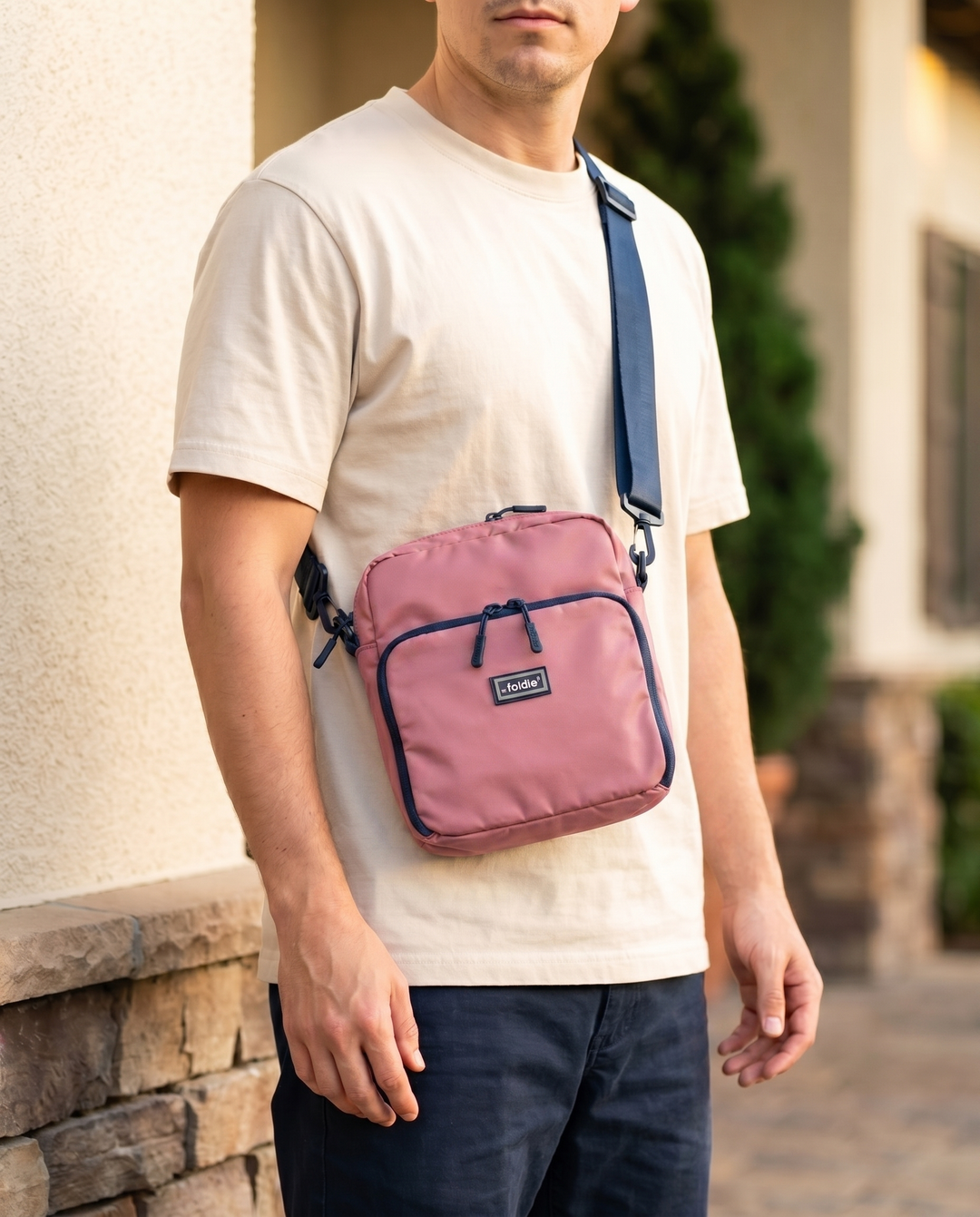 Foldable crossbody sling bag in Pink, worn