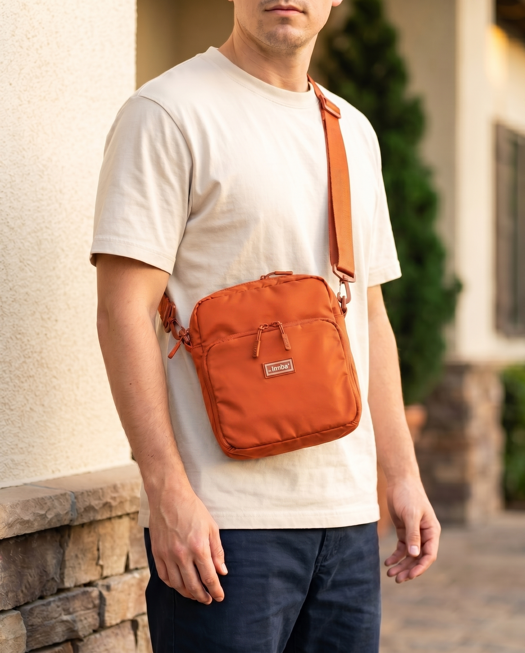 Foldable crossbody sling bag in Orange, worn