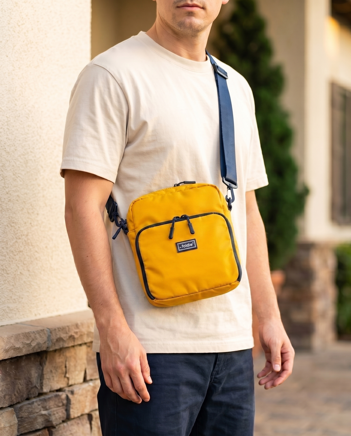 Foldable crossbody sling bag in Yellow, worn