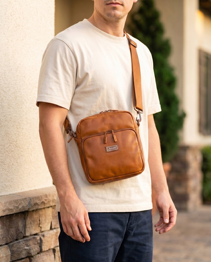 Foldable crossbody sling bag in Cognac, worn